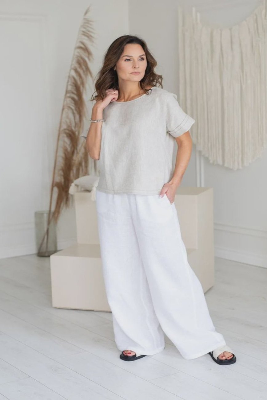 Woman wearing natural linen top with short sleeve and linen pants
