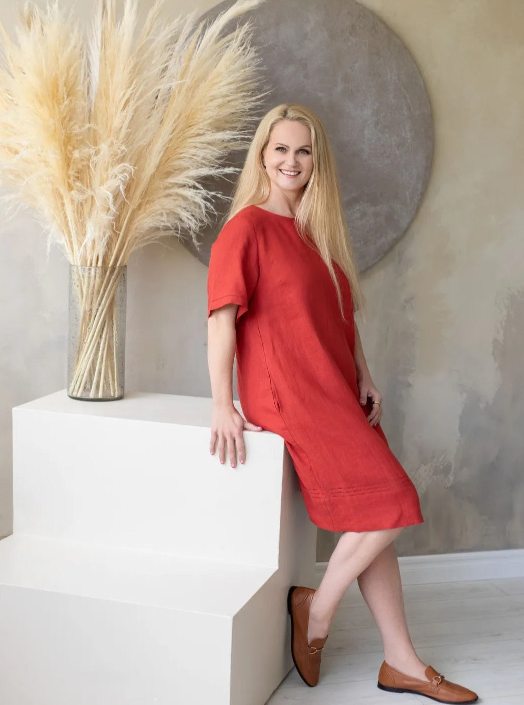 Woman wearing red linen shift dress