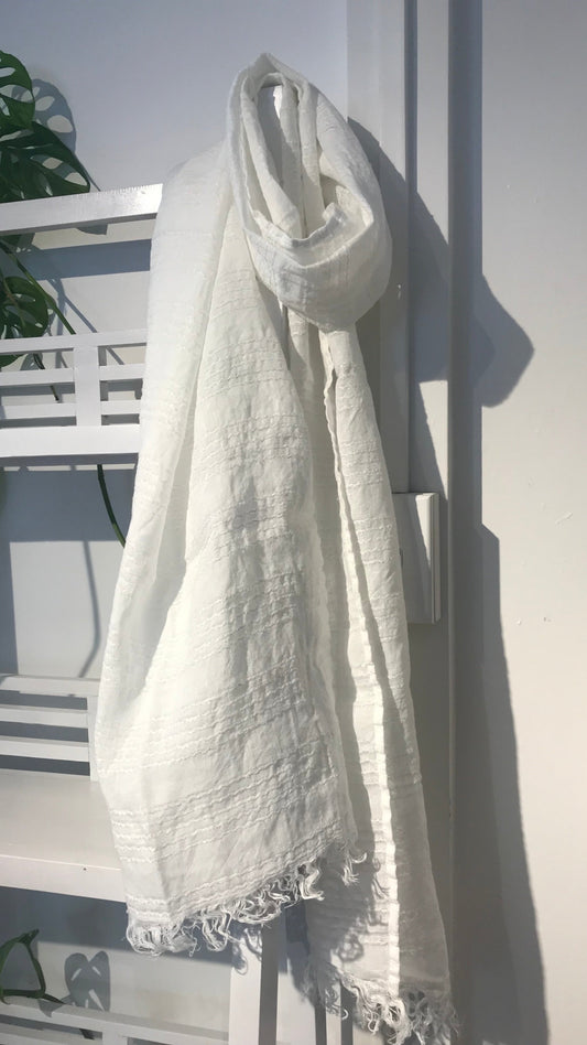 Linen scarf white stripe hanging on wooden shelf