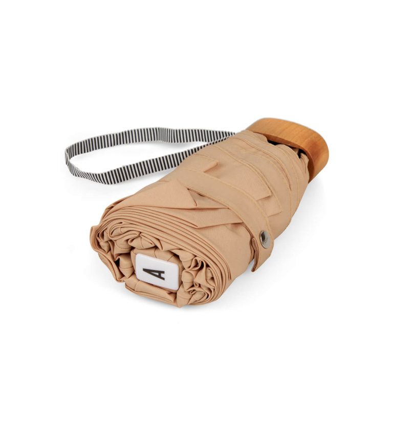 Beige umbrella folded from top