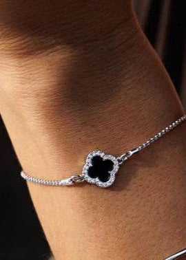 Woman's wrist wearing black flower bracelet in rhodium.