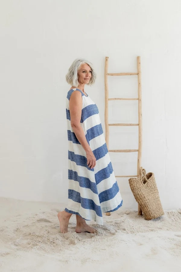 Woman wearing bold blue and white sleeveless stripe dress maxi