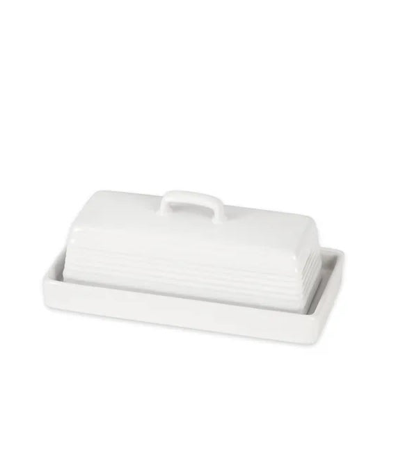 White ceramic butter dish with lid and handle on plain background