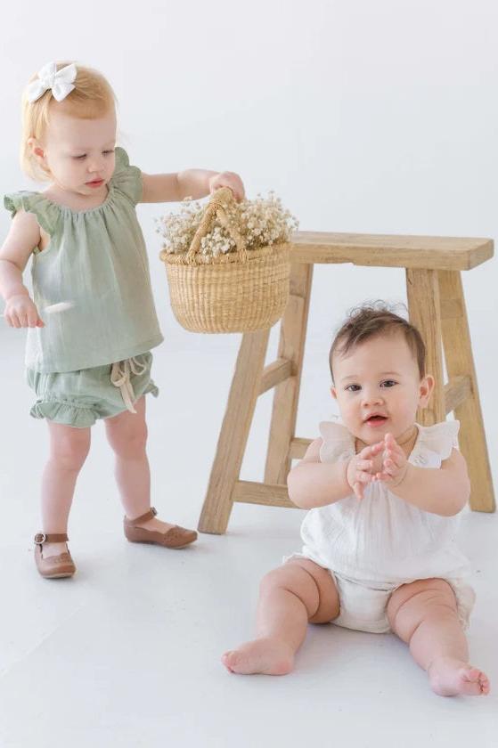 two children wearing cotton muslin blouse with ruffle sleeve & bloomer in sage and white