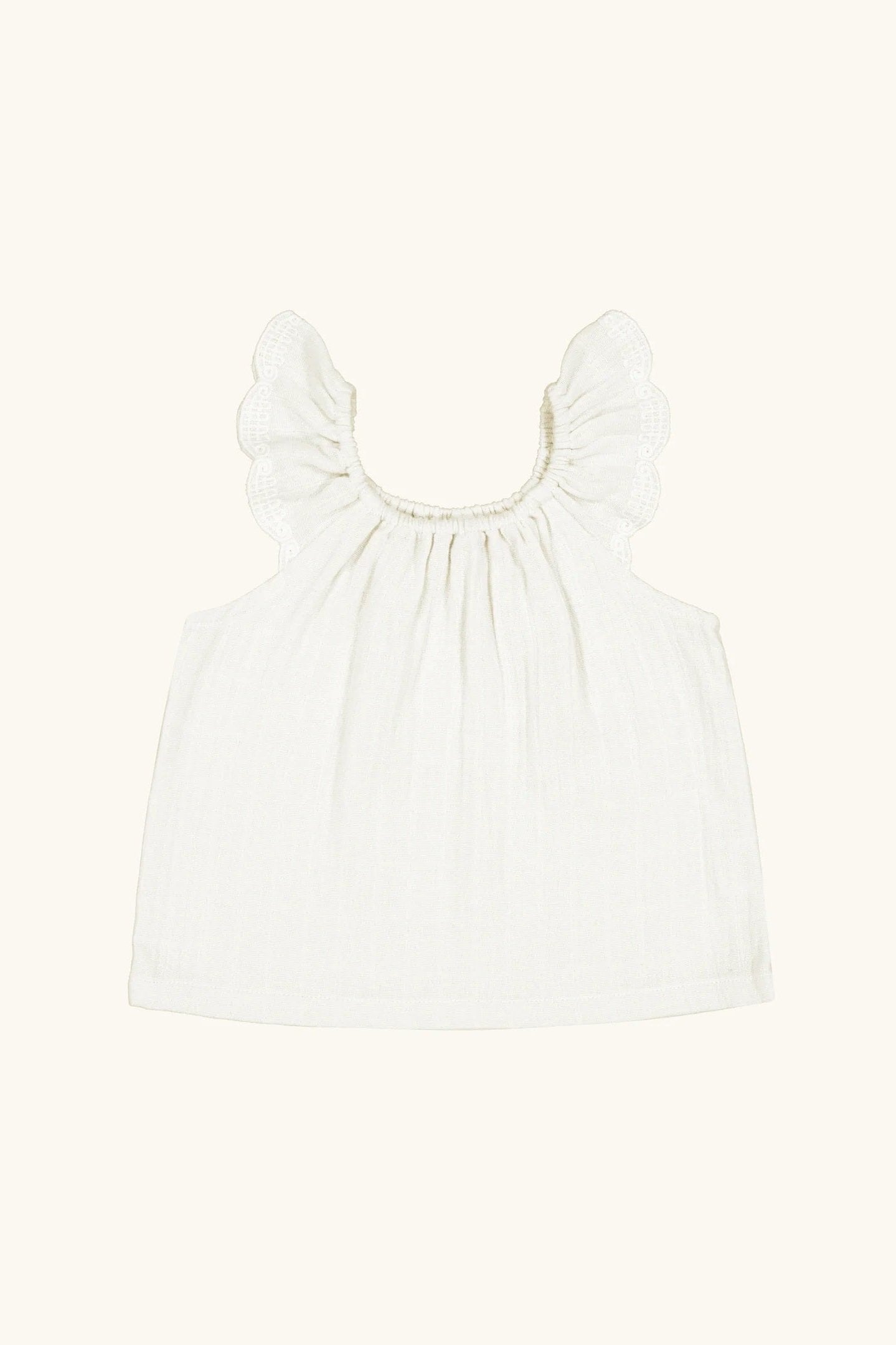 white sleeveless shoulder ruffle blouse in cotton muslin