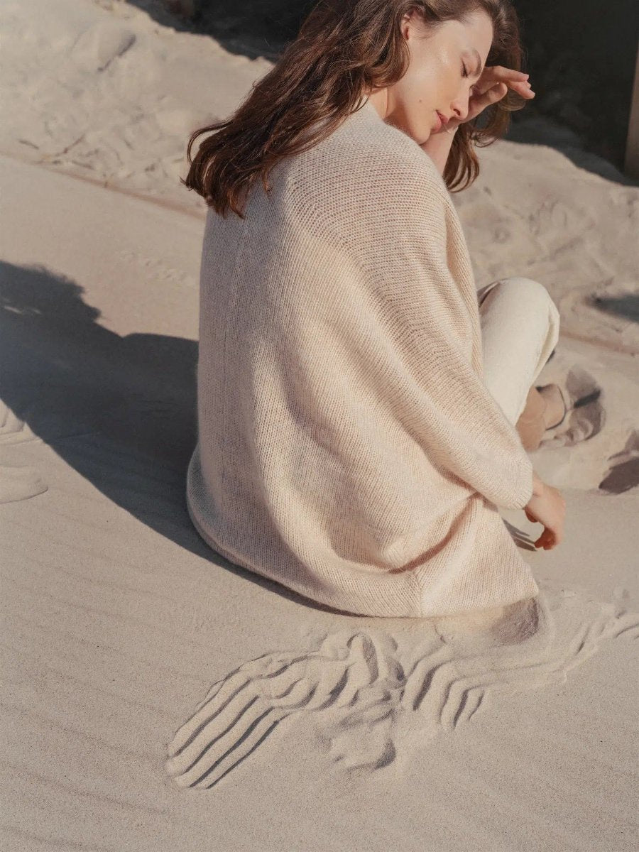 model seated wearing cream wrap
