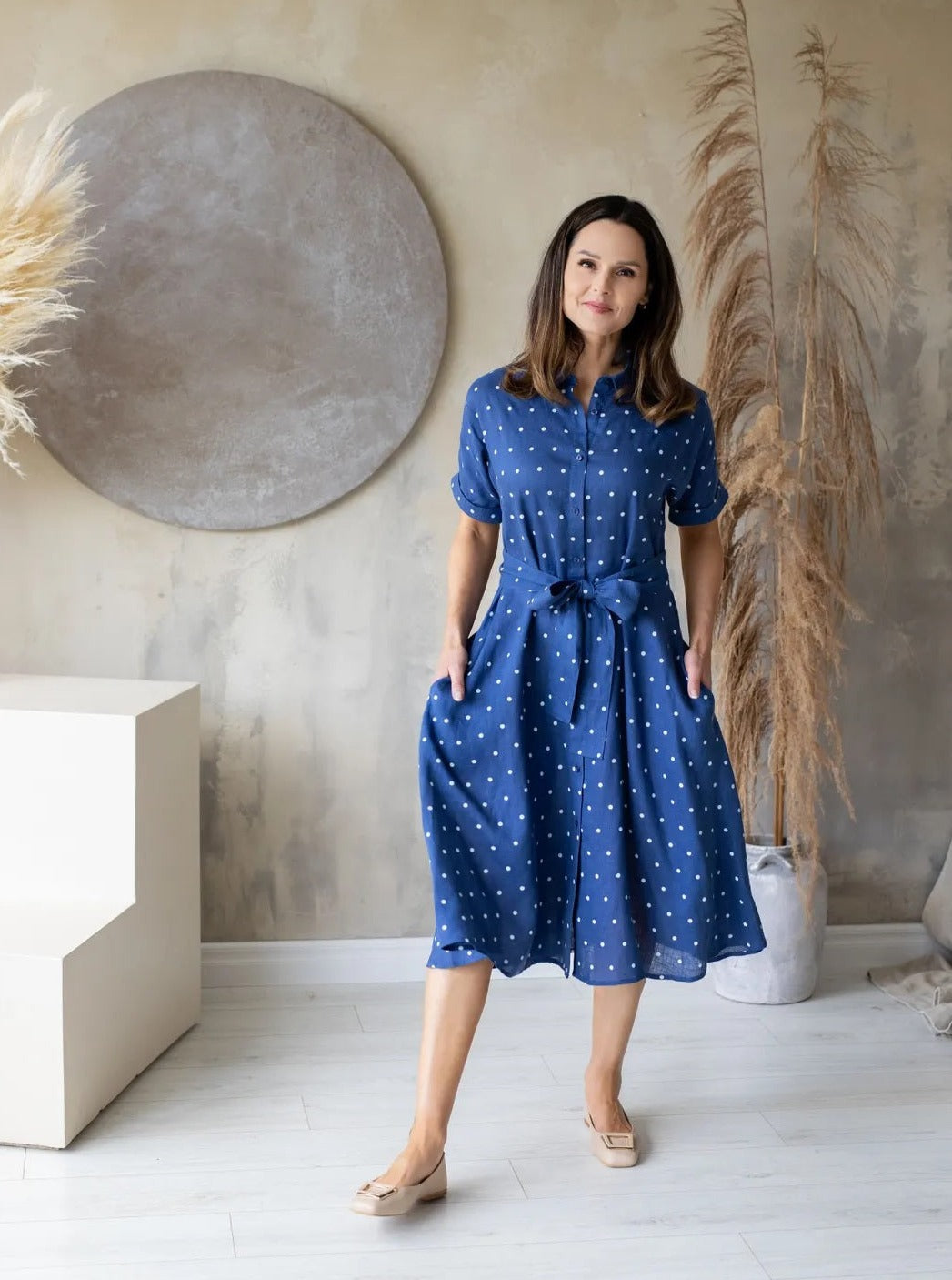 Woman wearing blue polka dot dress