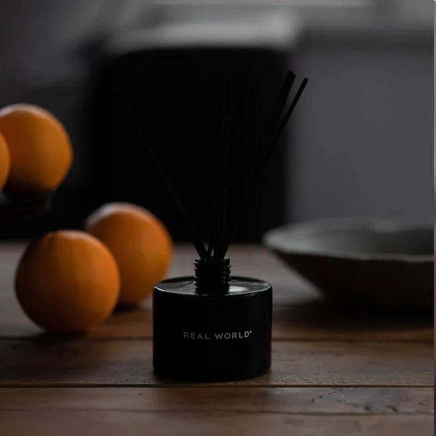 diffuser in black bottle on wooden bench