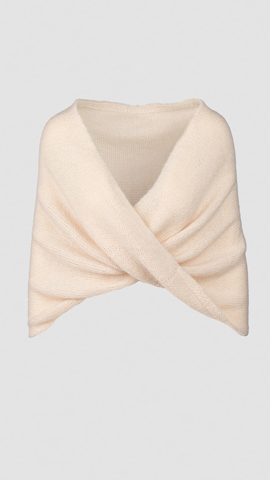 Knitted shawl with crossover design in pearl.