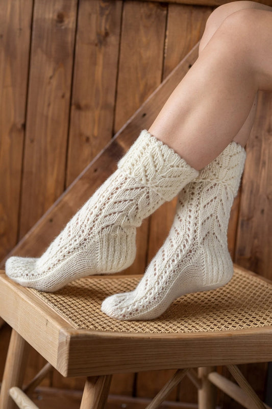 Knitted wool socis in winter white lace design.