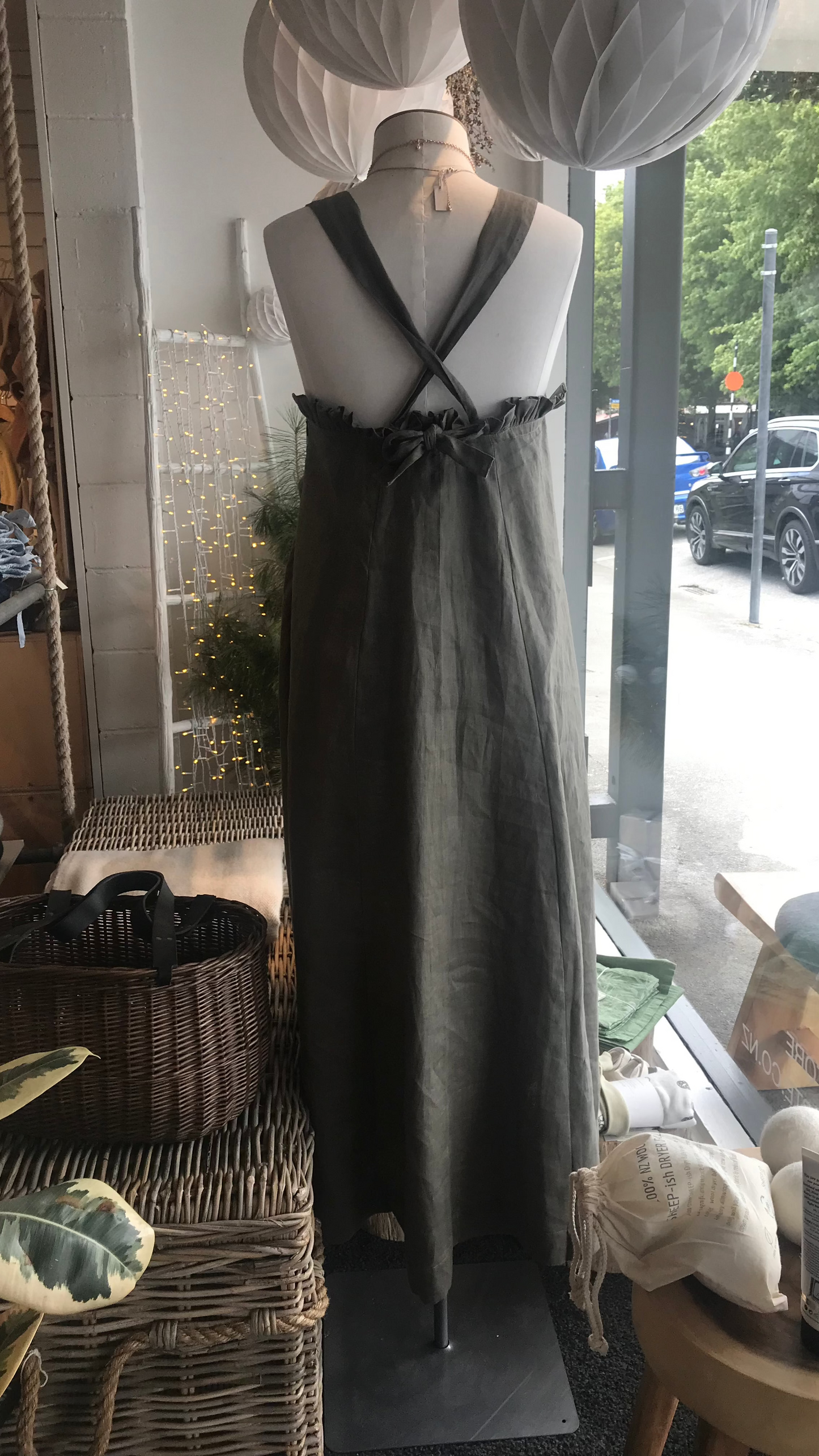 Susie khaki linen dress on mannequin back view with cross shoulder straps