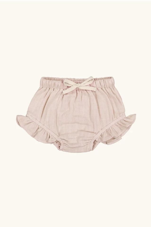 Light pink linen ruffle baby bloomers with bow, elastic waist, laid flat on white background