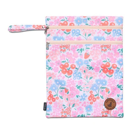 Floral pink reusable wet bag with zipper closure and wrist strap, ideal for travel or gym use.
