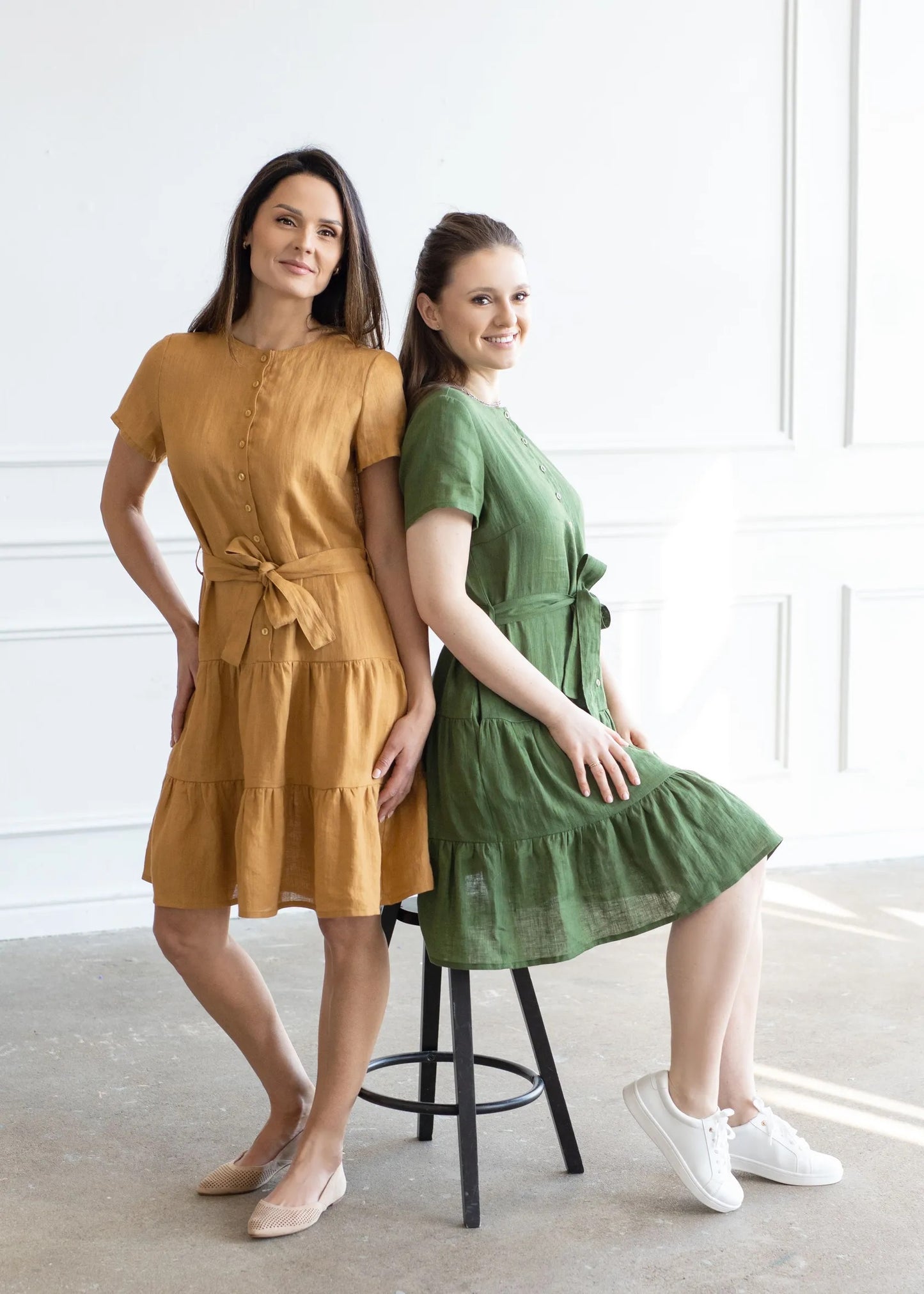 two ladies wearing short linen dresses