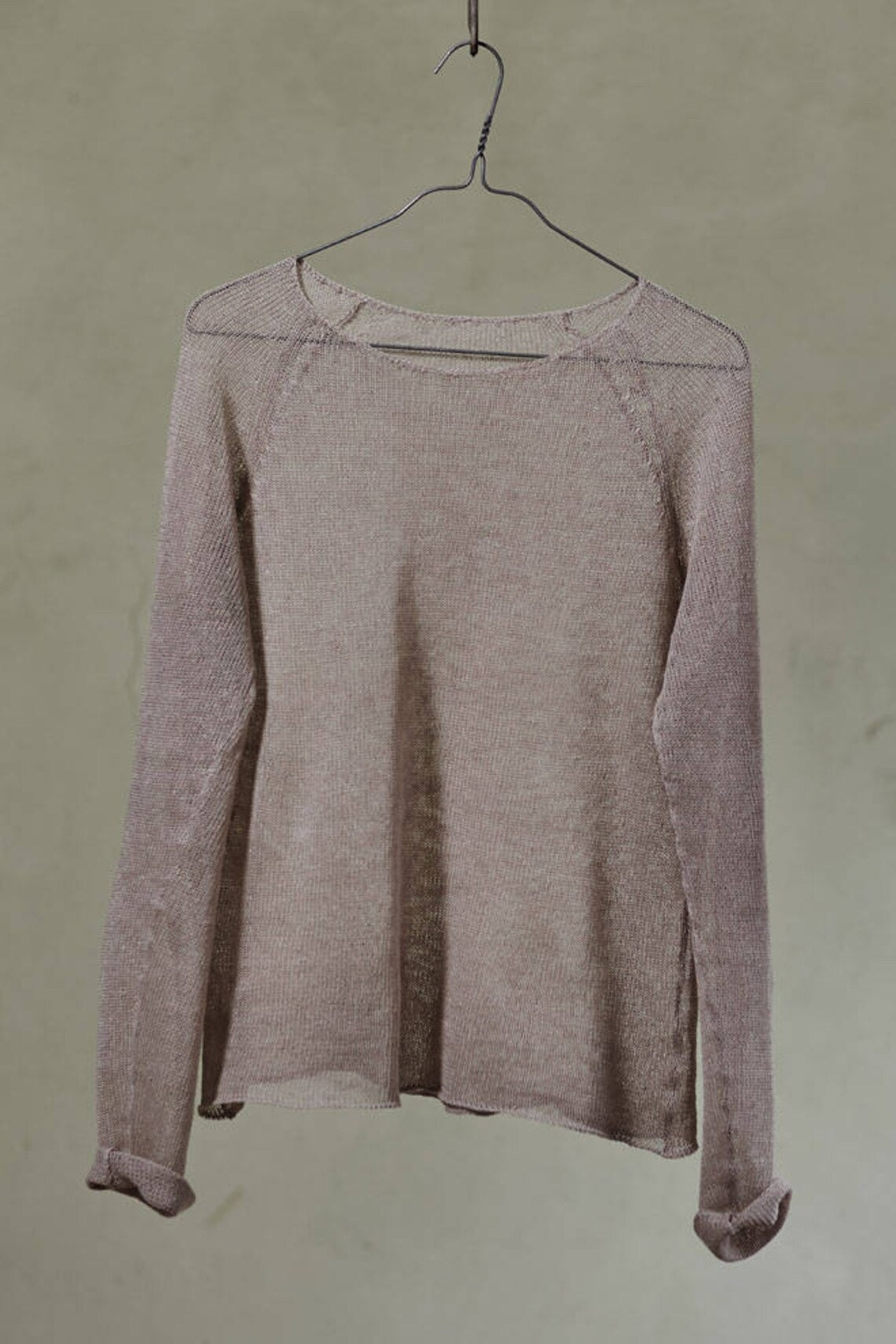 beige knitted sweater on hanger
