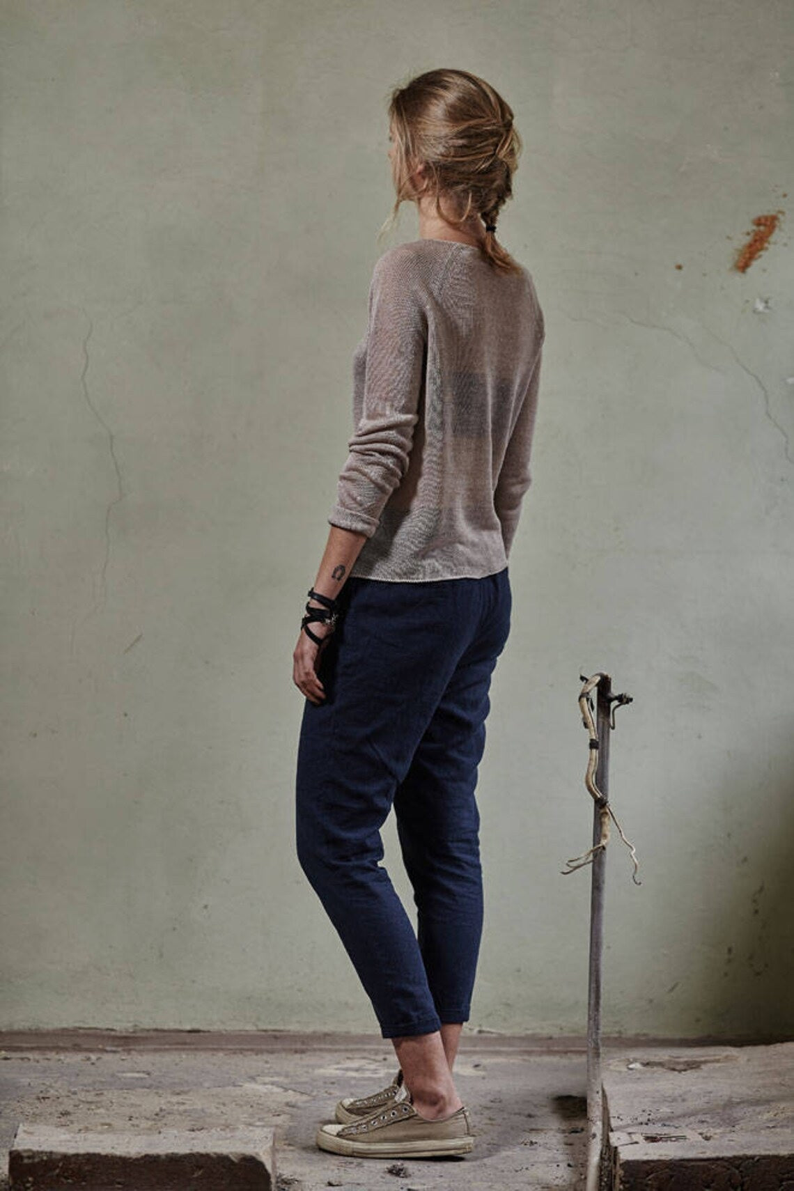 lady wearing beige knitted sweater back