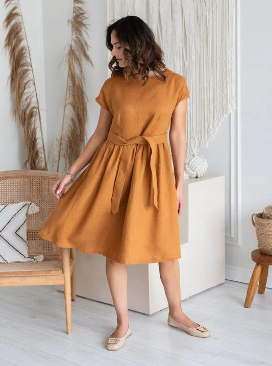 Woman wearing mustard linen dress front view