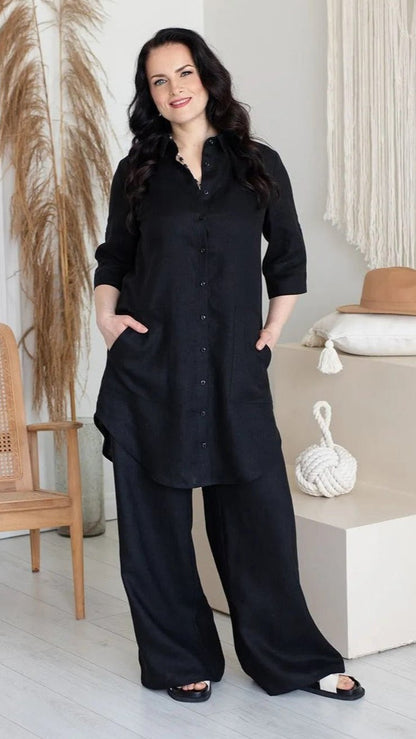 Woman wearing black shirt dress with pant