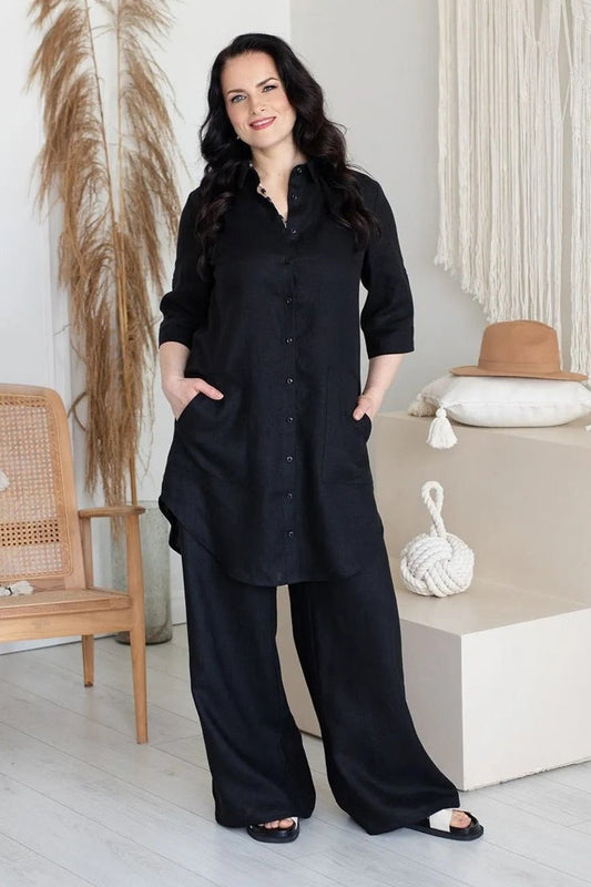 Woman wearing black shirt dress with pant