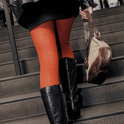 Woman wearing merino wool textured tights in spice.