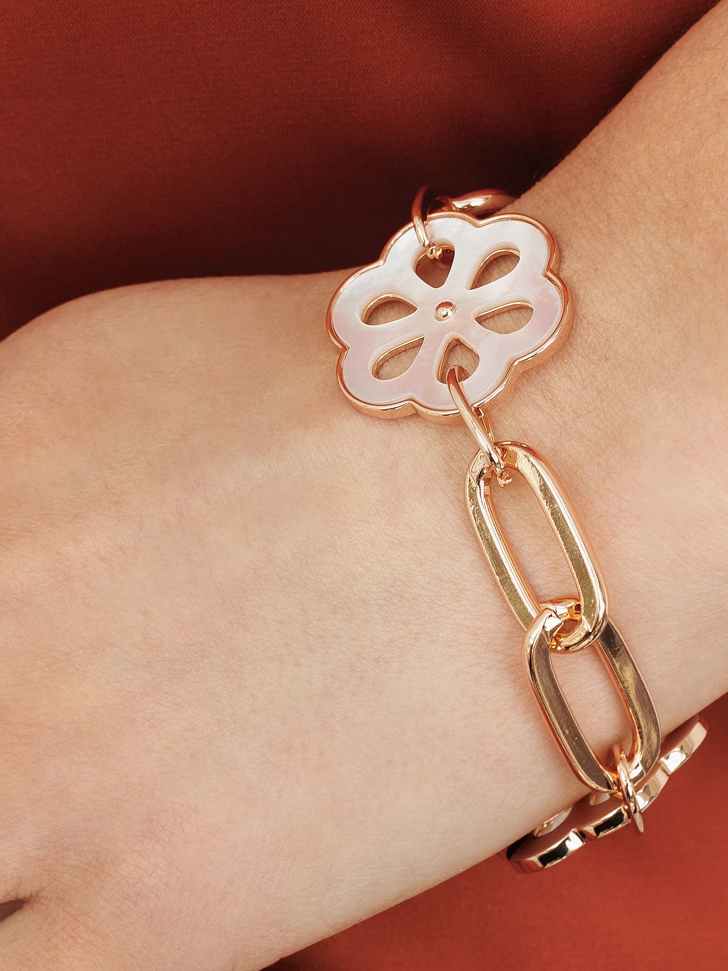 Rose gold chain bracelet with oversize shell flower.