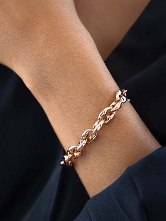 Woman wearing rose gold chunky link bracelet.