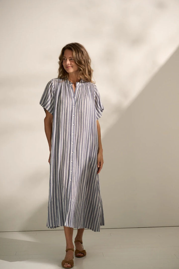 Woman wearing striped A-Line cotton shirt dress.
