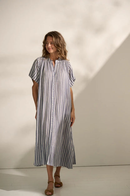 Woman wearing striped A-Line cotton shirt dress.