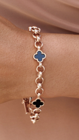 Model wearing rose gold chain bracelet with three black flowers