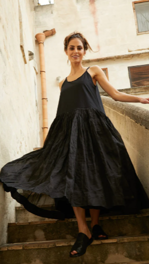 Woman wearing Tutu slip dress with cotton bodice and textured organdy skirt.