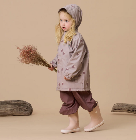 Child's waterproof playjacket in dusky pink with berry pattern.