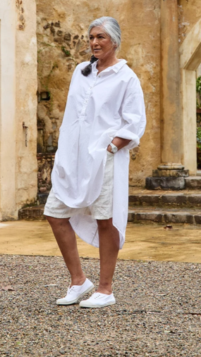 Woman wearing white shirt dress oversize