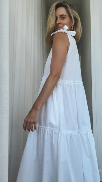 Model wearing white poplin dress tiered with tie shoulders