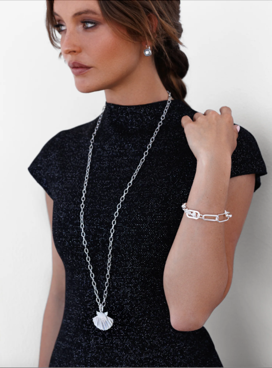 Woman wearing long shell necklace in rhodium plating.