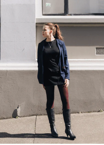 Woman wearing merino wool textured tights in currant.