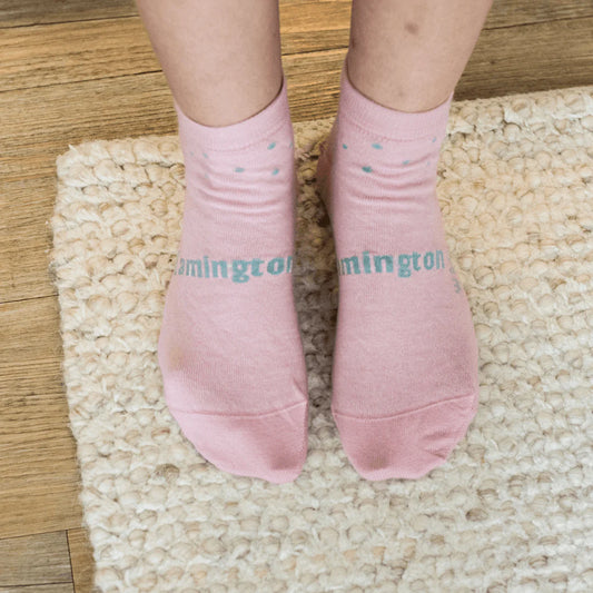 Woman wearihng vintage pink socks with pale green spots.
