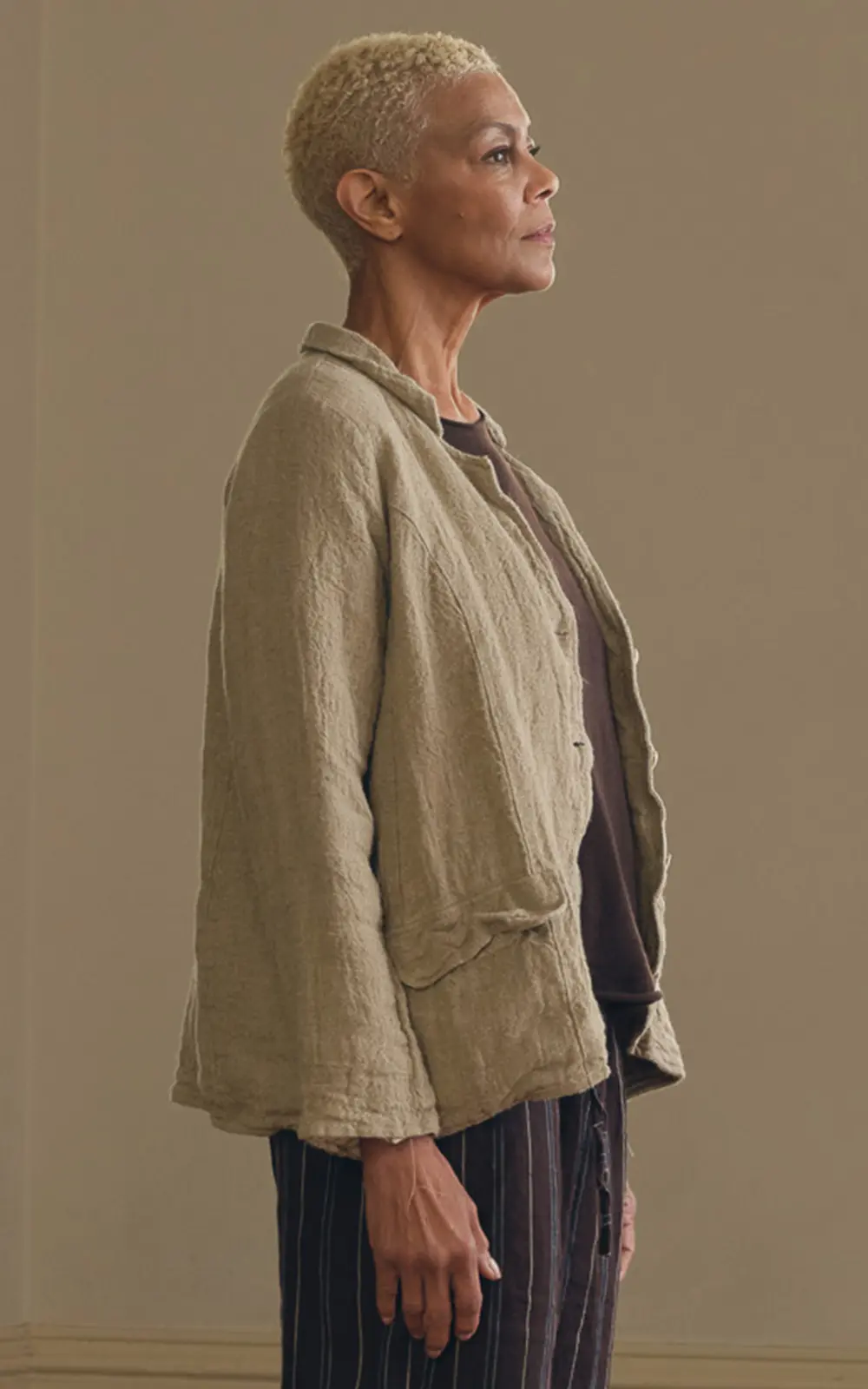 Woman wearing a raw linen jacket with relaxed fit and subtle natural texture