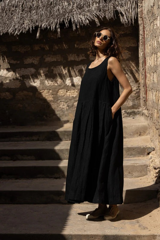 Woman wearing a linen sundress with pockets.