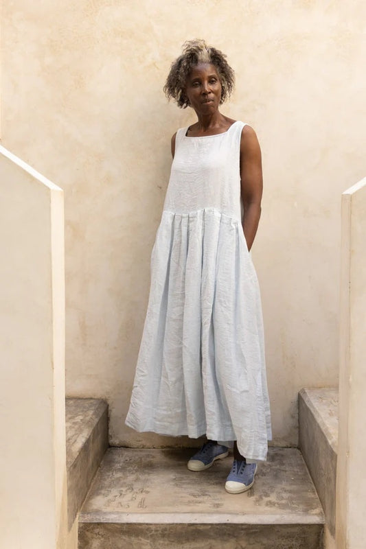 Woman wearing ice blue sundress angle view.