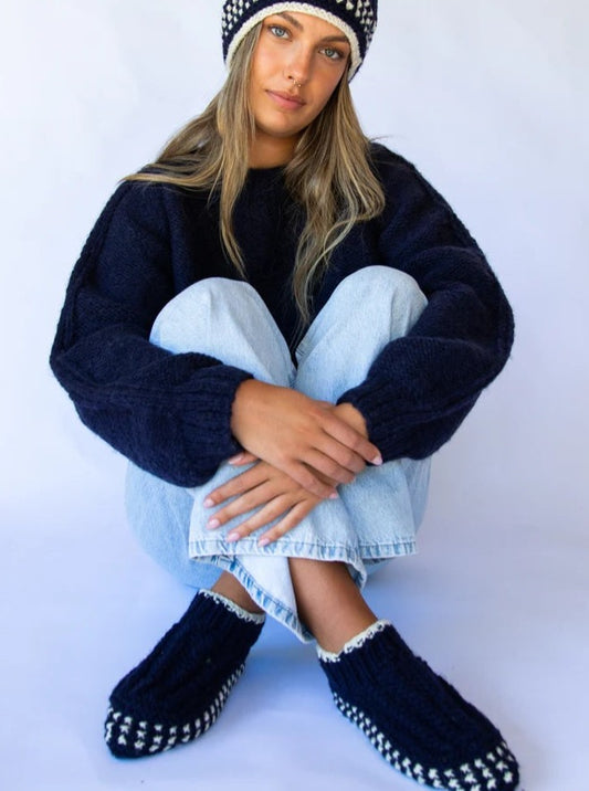 woman wearing navy knit bootie