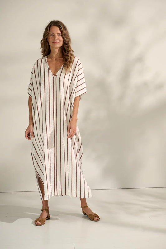 Woman wearing stripe kaftan dress.