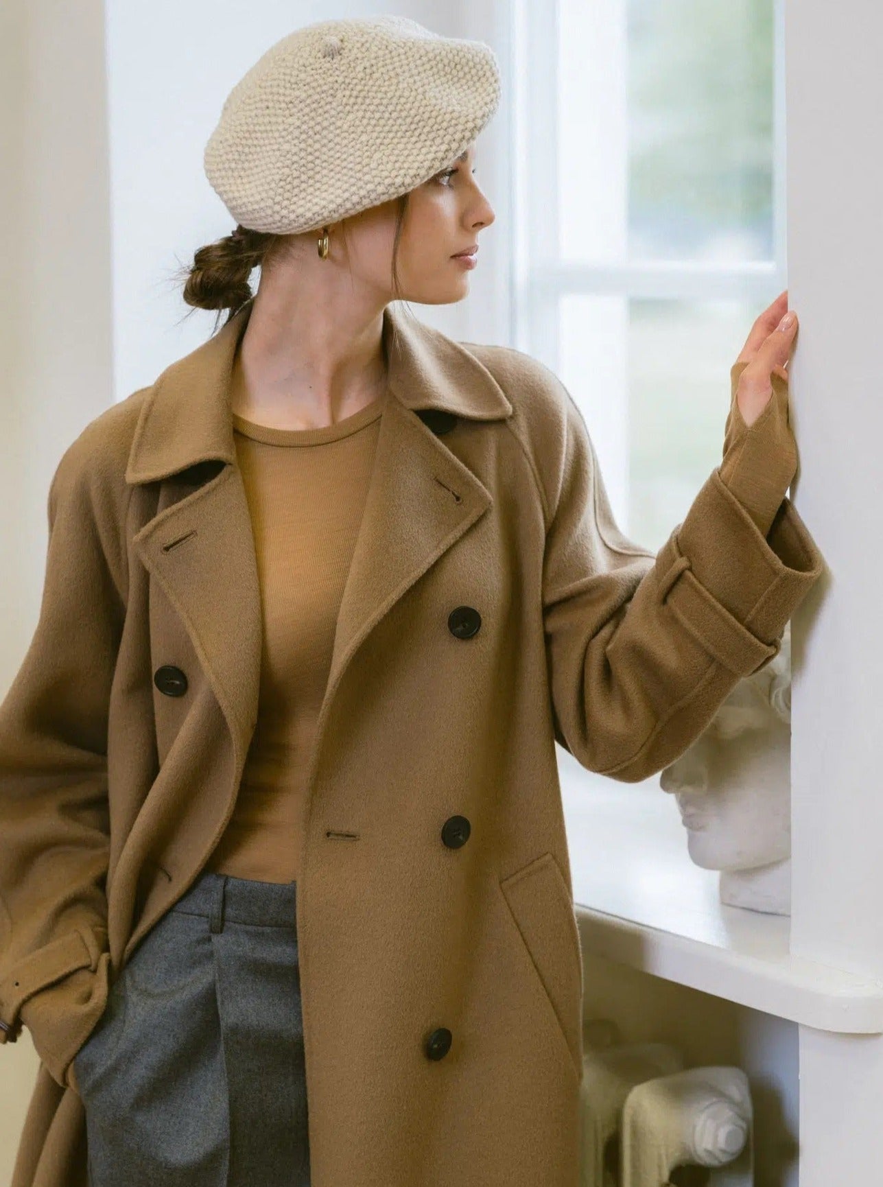 Woman wearing cream beret side view