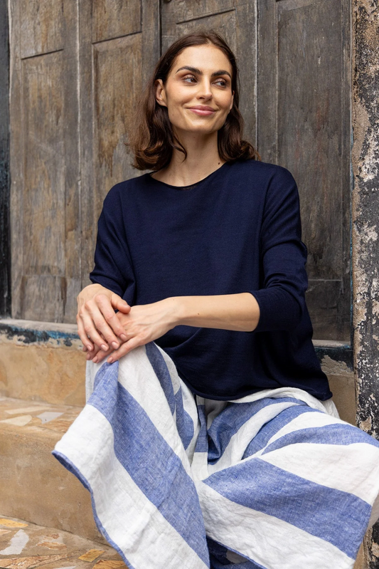 Woman wearing fine knit wool navy jumper.