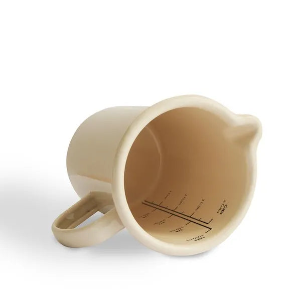Cream enamel jug with handle and interior measurement markings, kitchenware
