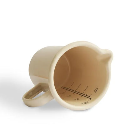 Cream enamel jug with handle and interior measurement markings, kitchenware