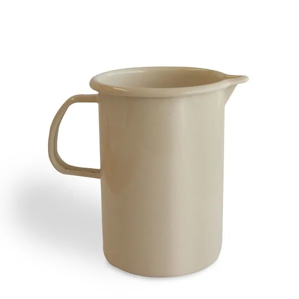 Ivory enamel jug with handle and spout on white background