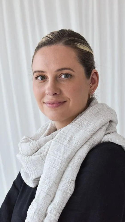 Woman wearing grey striped linen scart