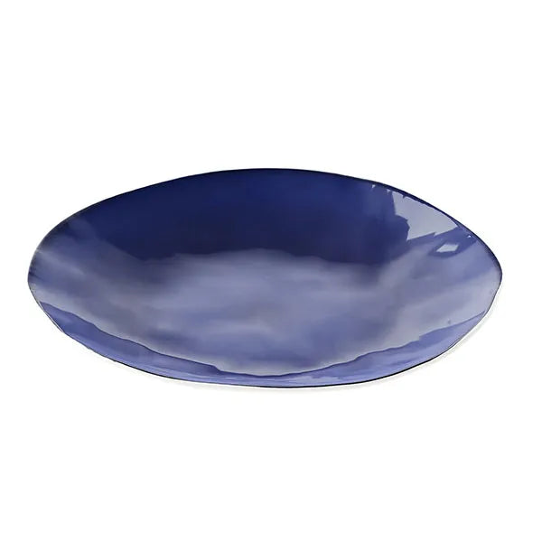 Deep blue ceramic dinner plate with glossy finish on a white background