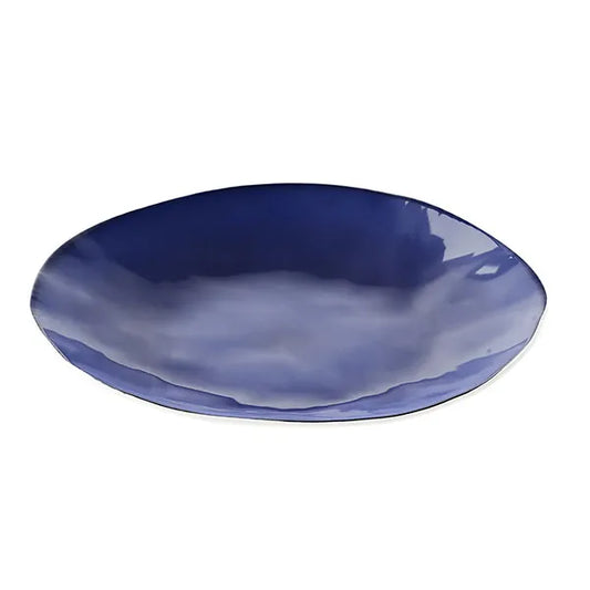 Deep blue ceramic dinner plate with glossy finish on a white background