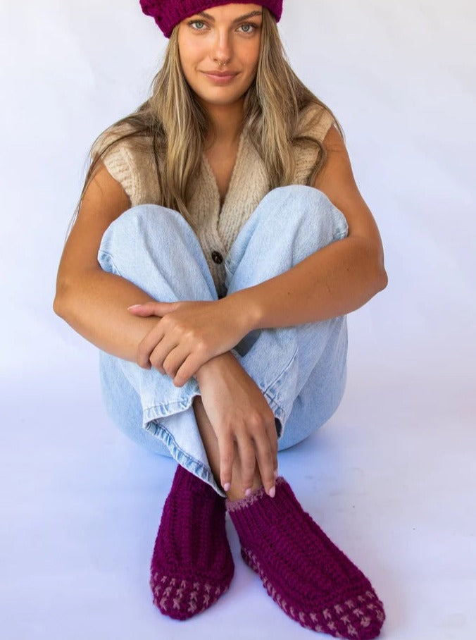 woman wearing berry coloured knit booties